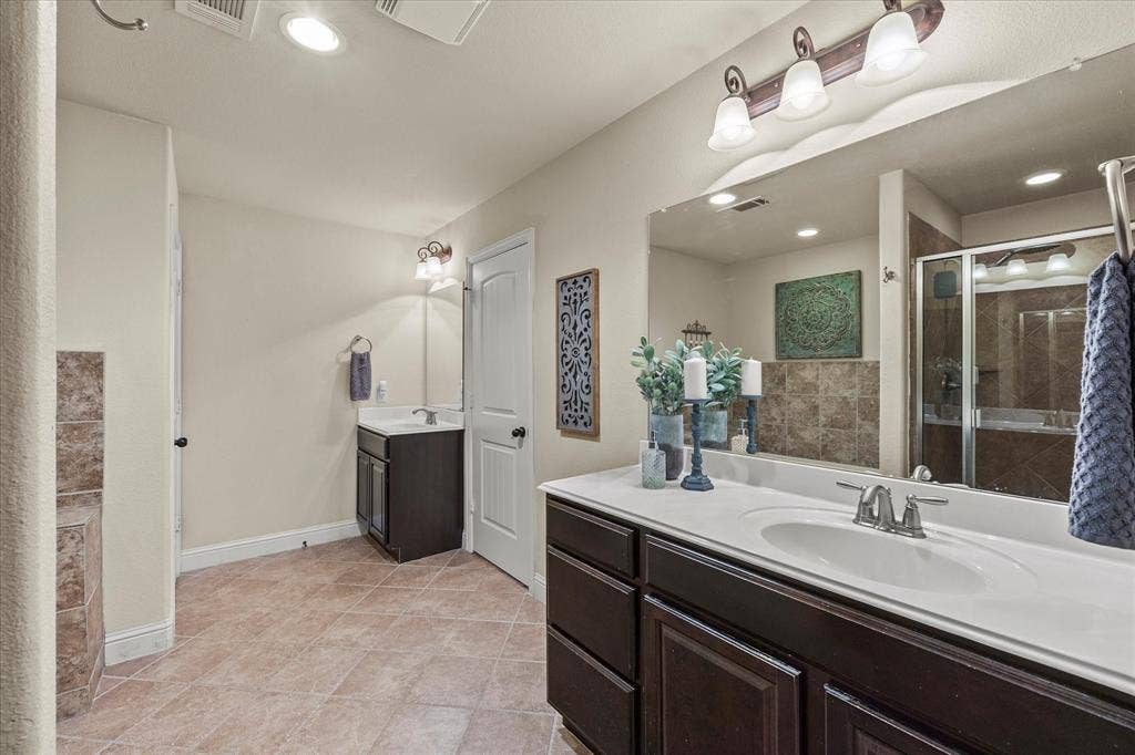 Gorgeous master bath includes his and her vanities with an abundance of cabinet space
