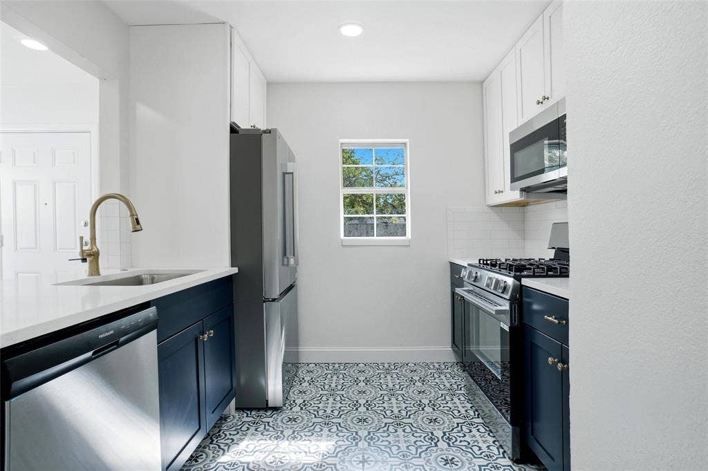 10430 Desdemona Drive, Dallas, TX 75228 Kitchen with new cabinets, appliances and quartz countertops and decorative ceramic tile floor.