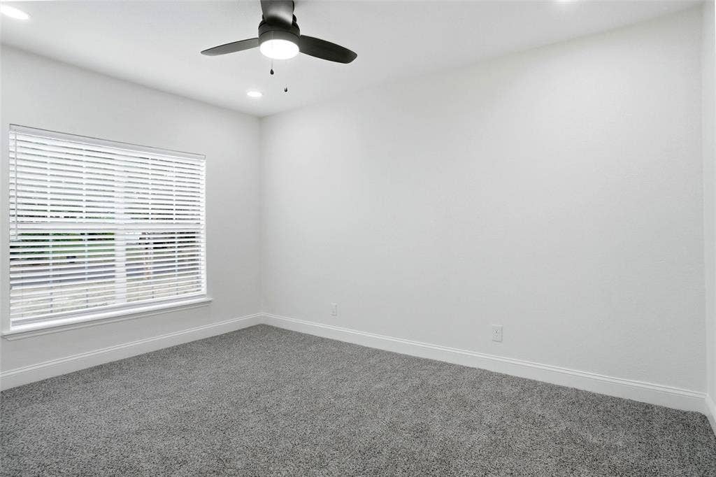 10430 Desdemona Drive, Dallas, TX 75228 Primary bedroom with new carpet and remote control ceiling fan