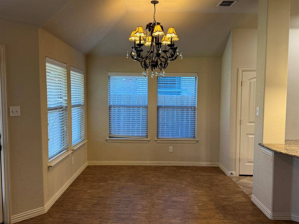 3953 Hollow Lake Road, Fort Worth, TX 76262 Vaulted ceiling, wood-finish flooring, multi-pane windows with horizontal blinds, and a traditional tiered chandelier