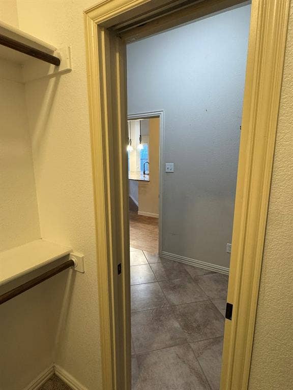 3953 Hollow Lake Road, Fort Worth, TX 76262 Built-in shelving and hanging rod with tile flooring