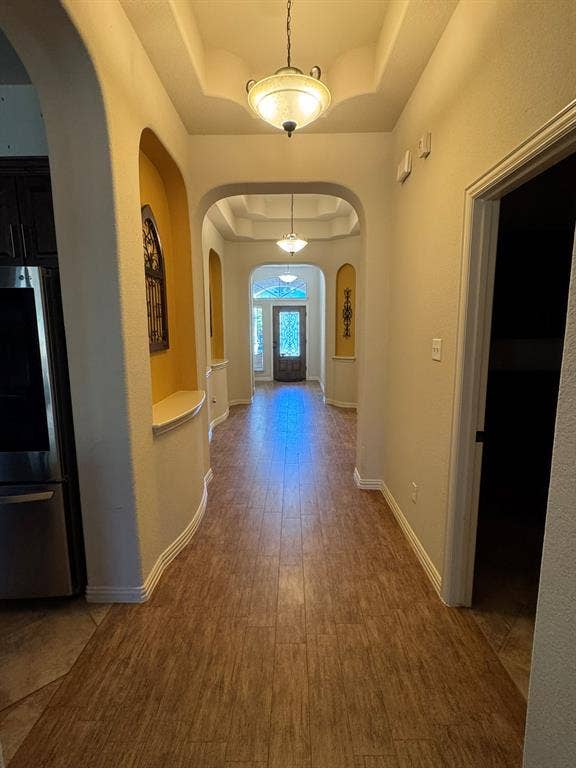 3953 Hollow Lake Road, Fort Worth, TX 76262 Entryway featuring wood-finish flooring, recessed ceilings, arched architectural alcoves, and decorative pendant lighting