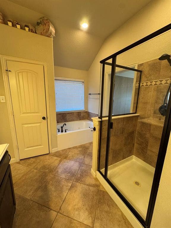 3953 Hollow Lake Road, Fort Worth, TX 76262 Soaking tub with tile surround, glass-enclosed shower with tiled walls, and large-format tile flooring