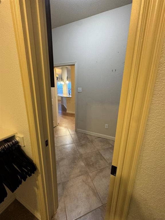 3953 Hollow Lake Road, Fort Worth, TX 76262 Tiled flooring featuring large-format ceramic tiles with a neutral stone pattern