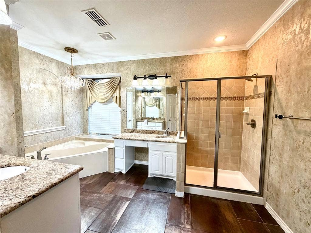 4514 Sea Sparrow Lane, Garland, TX 75043 Bathroom featuring wood-finish flooring, white cabinetry with stone-surface countertops, a soaking tub, and a separate glass-enclosed shower with tiled walls