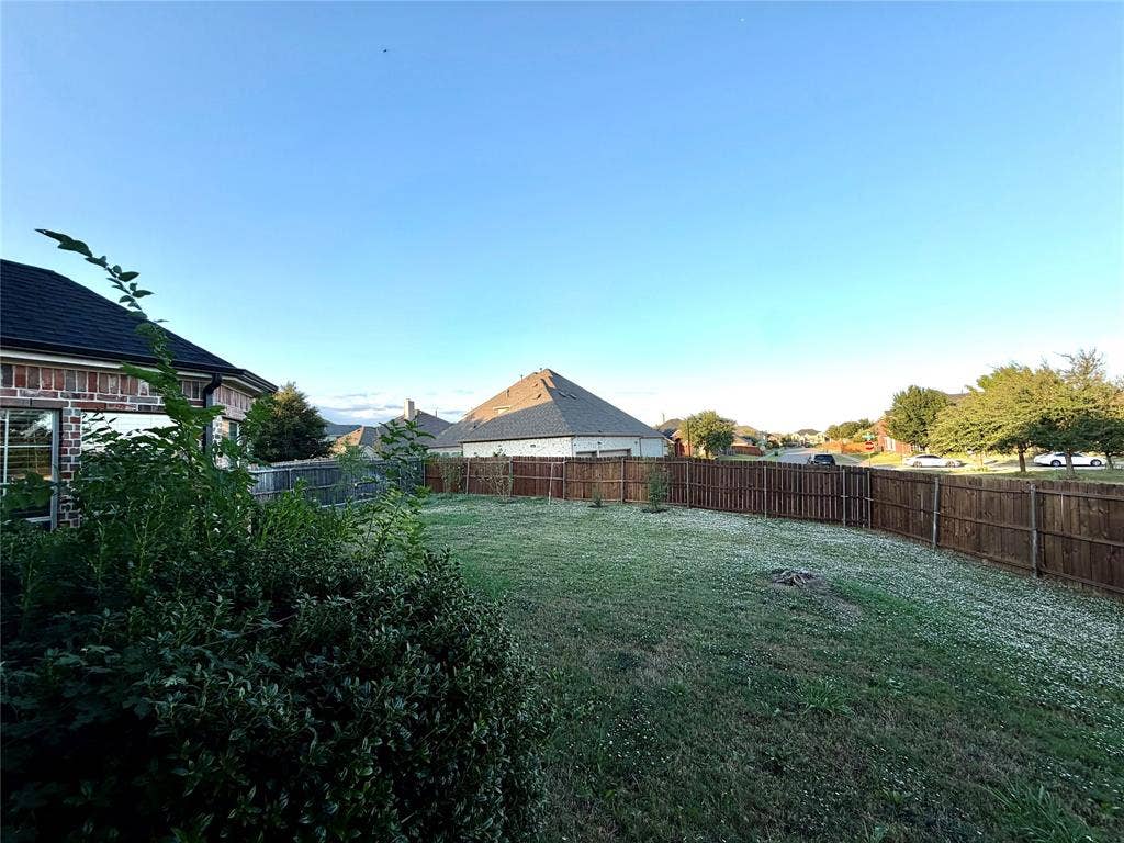 4514 Sea Sparrow Lane, Garland, TX 75043 Backyard featuring a grass lawn and a wood privacy fence