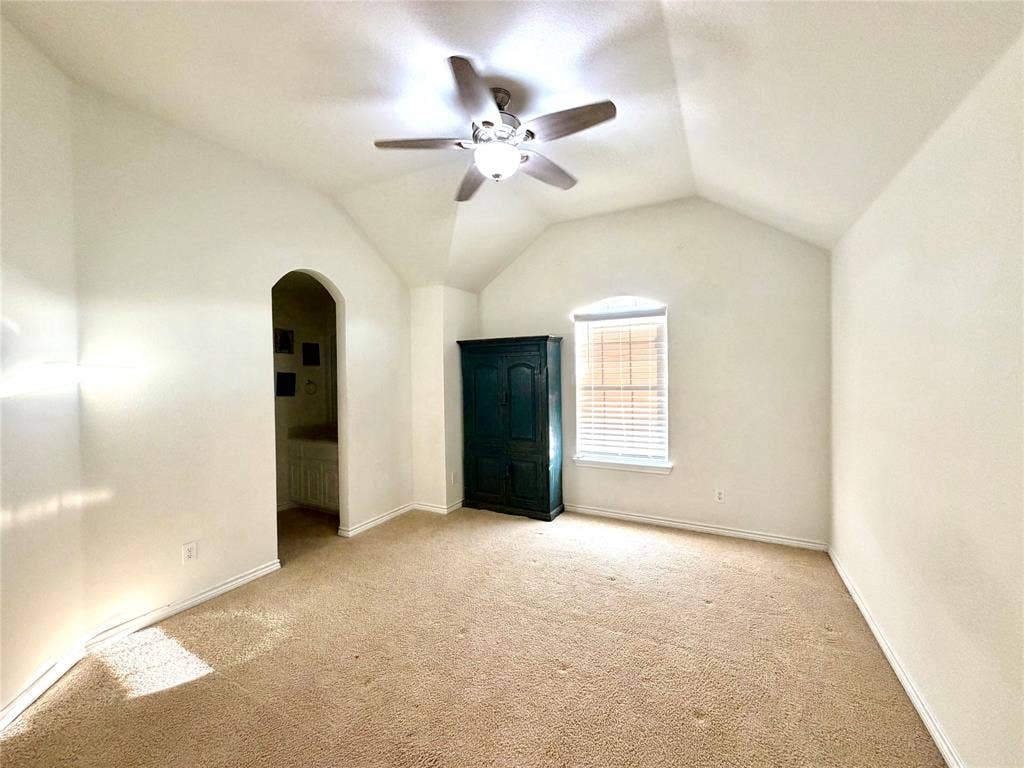 4514 Sea Sparrow Lane, Garland, TX 75043 Vaulted ceiling featuring an arched doorway and a central ceiling fan with an integrated light fixture