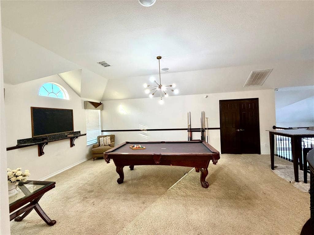4514 Sea Sparrow Lane, Garland, TX 75043 Vaulted ceilings featuring a multi-arm sputnik-style chandelier, arched window, wall-mounted stone shelf, and double-door entry