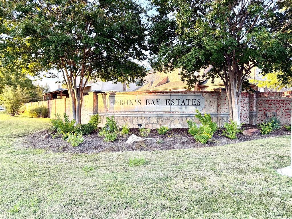 4514 Sea Sparrow Lane, Garland, TX 75043 Community entrance signage featuring brick masonry construction, decorative stonework, and mature trees