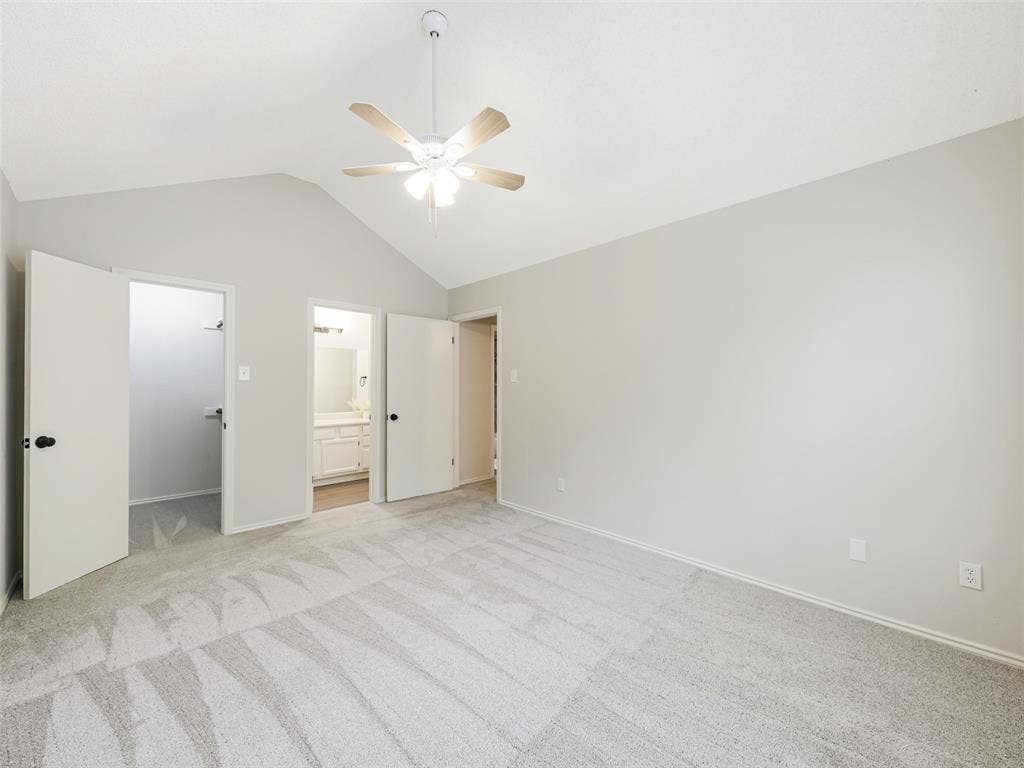 449 Harris Street, #102L, Coppell, TX 75019 Vaulted ceilings featuring a central overhead fan with light fixture, neutral wall finishes, and carpeting