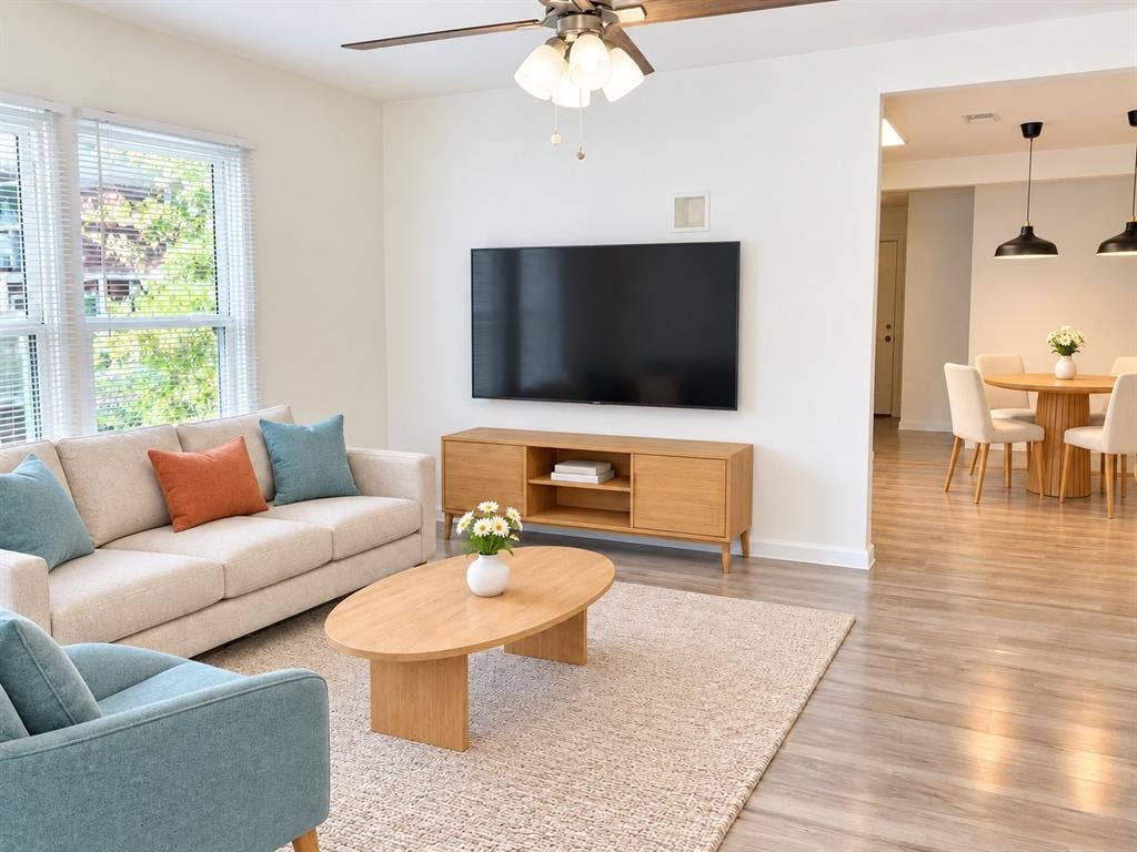 Living space featuring wood-finish flooring, recessed ceiling lighting, and multi-paned windows