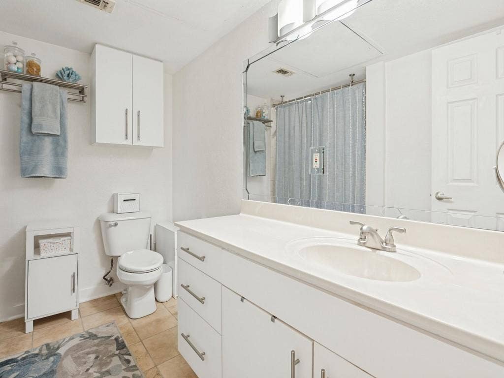 Bath with Tub Shower and oversized vanity with plenty of storage.