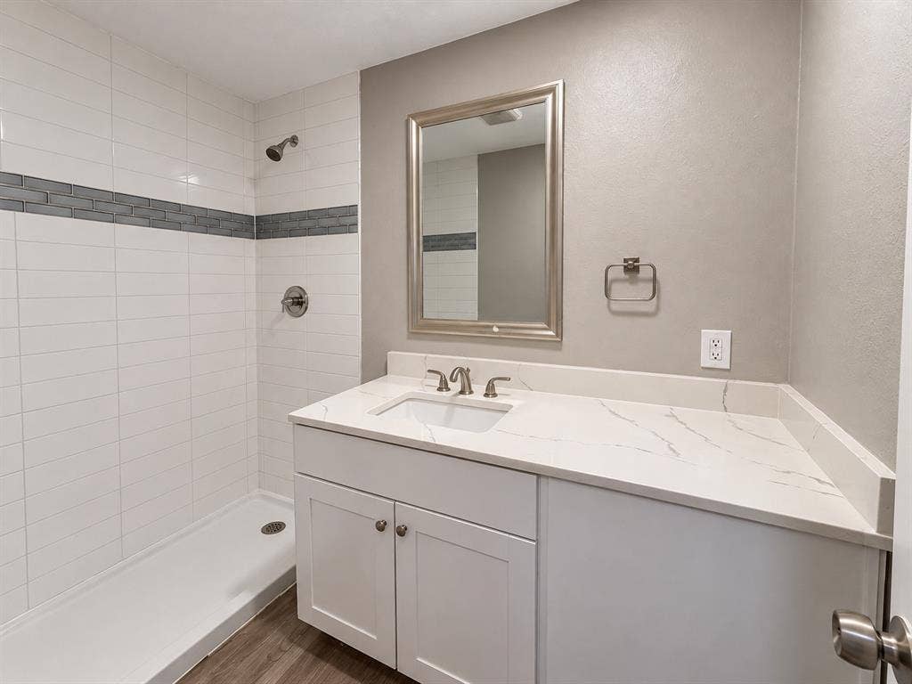 5140 Dimple Jackson Street, Dallas, TX 75210 Updated bathroom featuring a spacious vanity, modern countertop, and tiled shower.