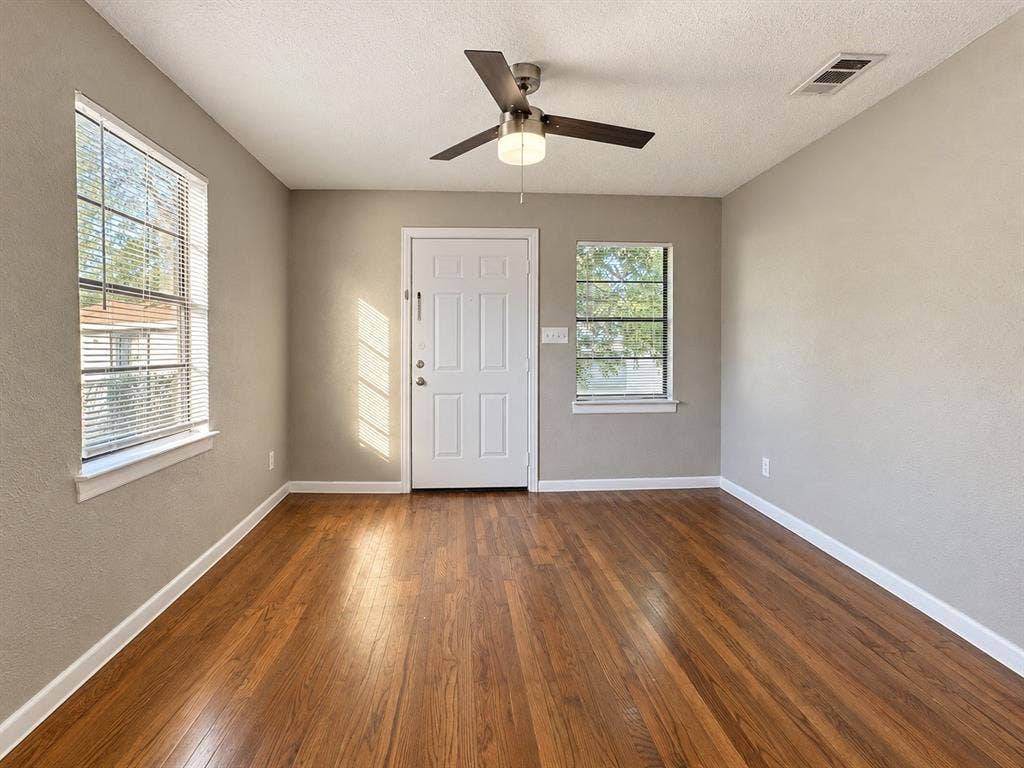5140 Dimple Jackson Street, Dallas, TX 75210 Bedroom / Office (Unstaged)Additional view of the room featuring wood flooring, ceiling fan, and natural light.