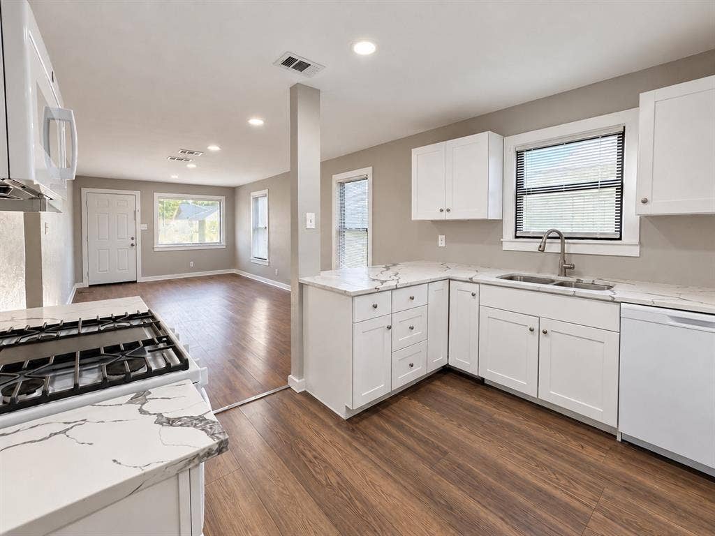 5140 Dimple Jackson Street, Dallas, TX 75210 Functional kitchen layout featuring white cabinetry, modern finishes, and ample counter space.