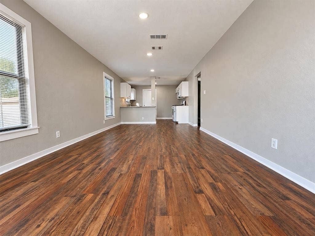 5140 Dimple Jackson Street, Dallas, TX 75210 Open-concept living space featuring beautiful wood flooring and recessed lighting.