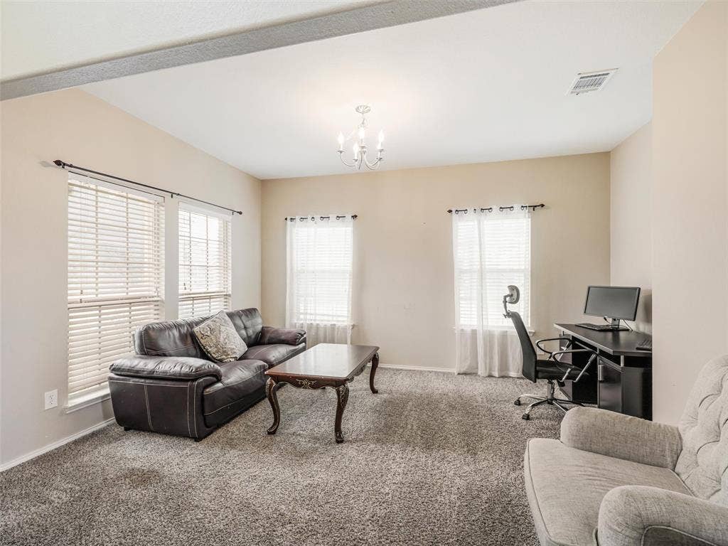 9720 Tipperary Drive, McKinney, TX 75072 Living area featuring wall-to-wall carpeting, multiple windows with neutral blinds, and an overhead chandelier