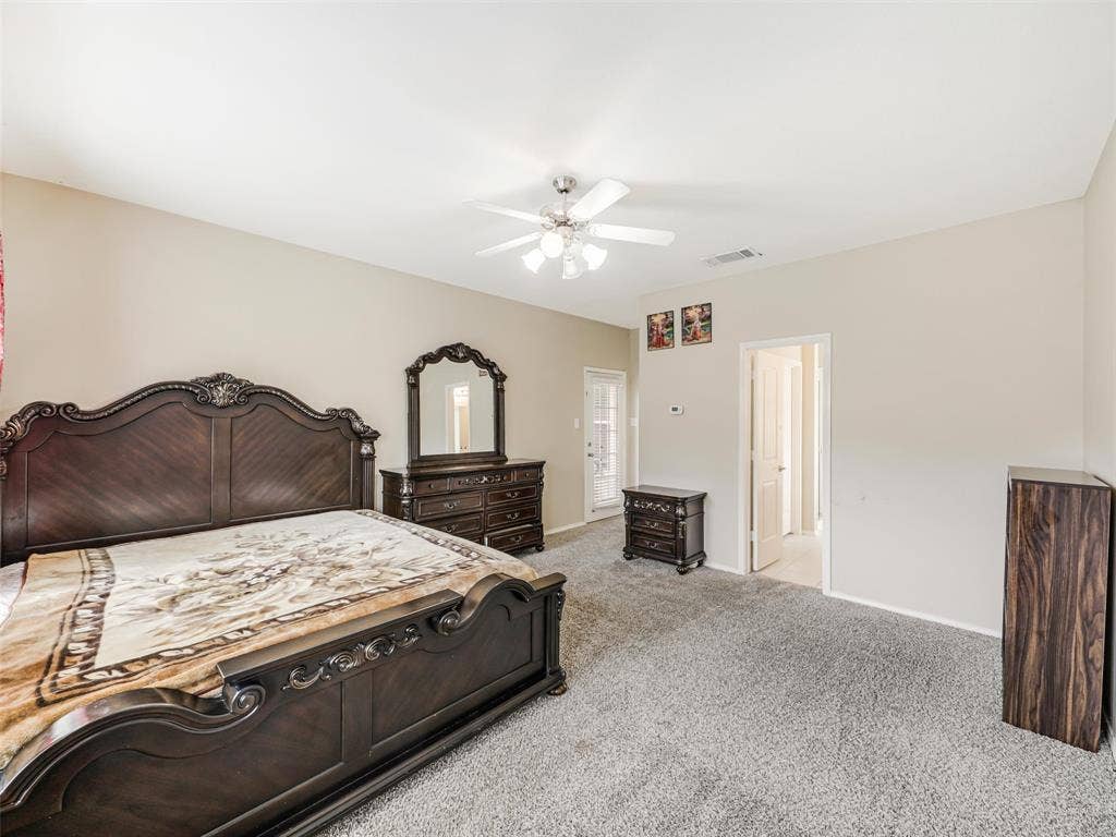 9720 Tipperary Drive, McKinney, TX 75072 Neutral wall tones, carpeting, ceiling fan with integrated lighting, and glass-paneled exterior door