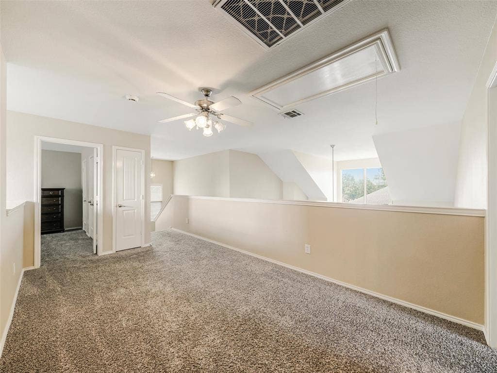 9720 Tipperary Drive, McKinney, TX 75072 Open area featuring neutral carpet flooring, a ceiling fan with integrated lighting, and an attic access panel