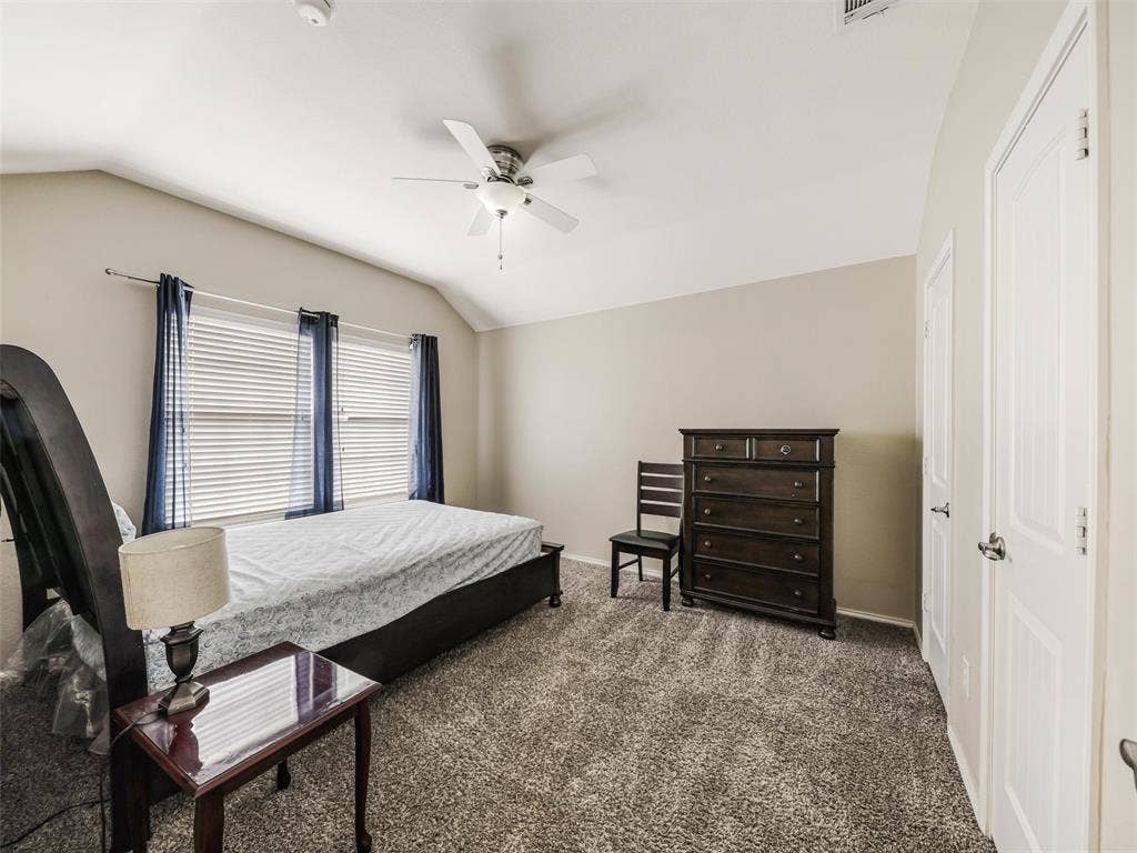 9720 Tipperary Drive, McKinney, TX 75072 Vaulted ceiling, neutral wall tones, multi-textured carpeting, and a ceiling-mounted light fixture with integrated fan