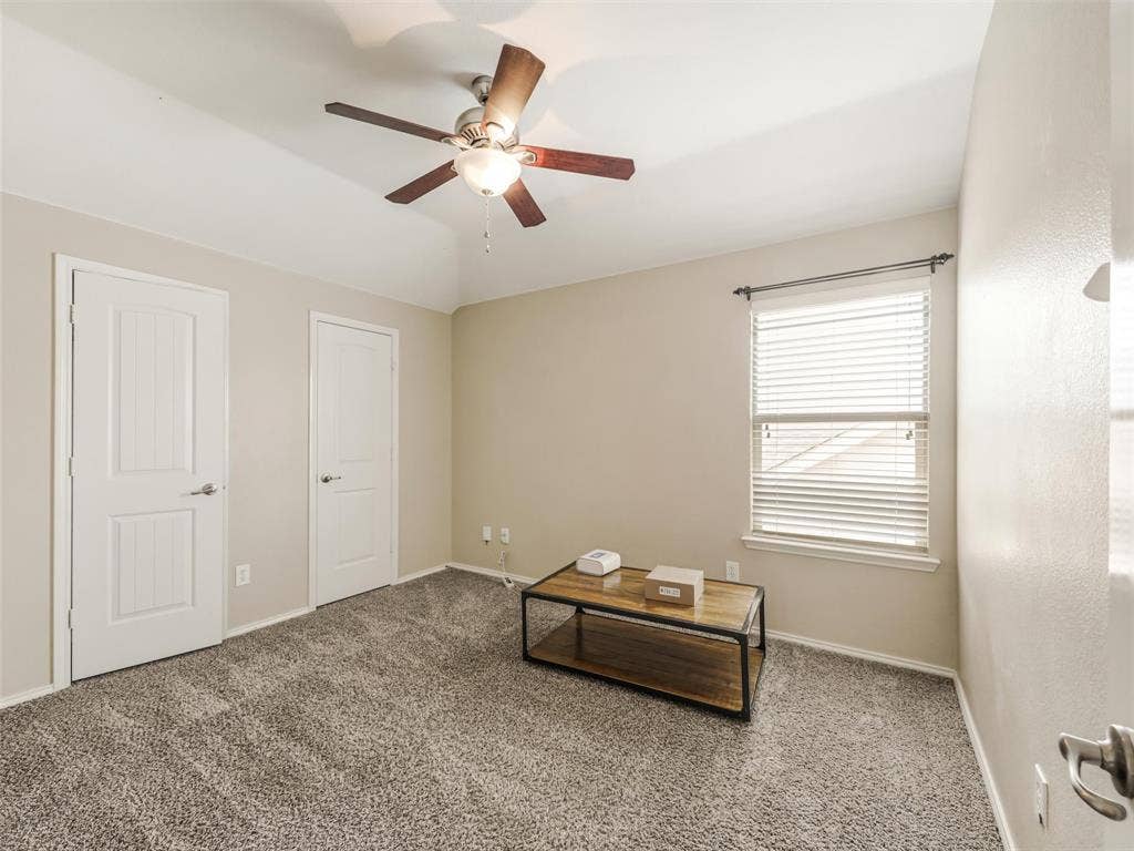 9720 Tipperary Drive, McKinney, TX 75072 Neutral wall color, carpeted flooring, vaulted ceiling, ceiling fan with light kit, and two interior doors