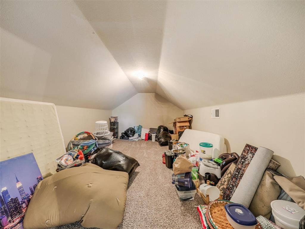 9720 Tipperary Drive, McKinney, TX 75072 Finished attic space featuring vaulted ceilings and carpeting