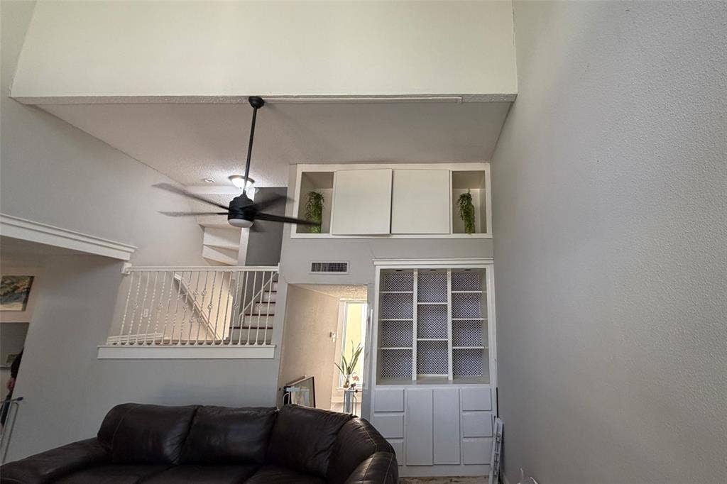 Living Room Facing Stairs to Second Level - High Storage Area Behind Built-In Double Doors