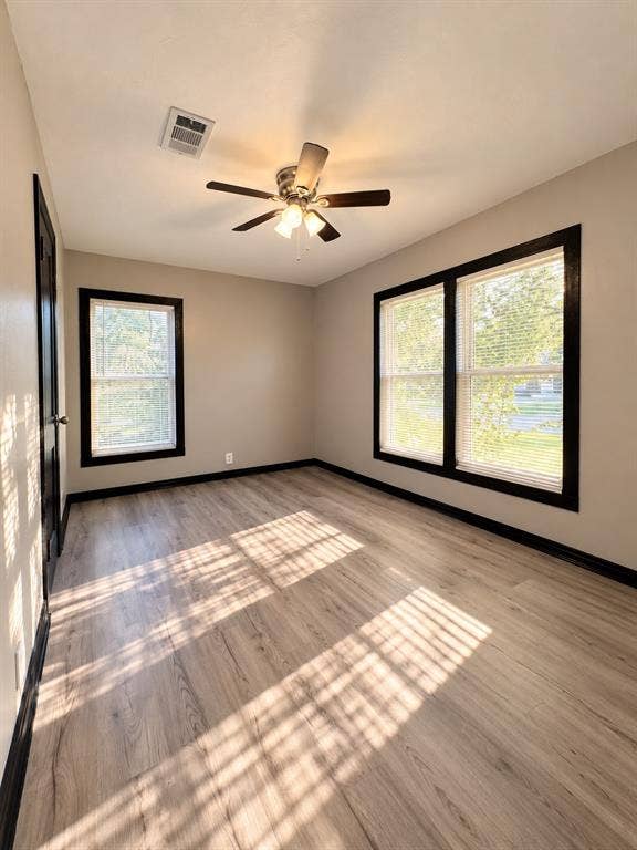 1817 N Alexander Street, Sherman, TX 75092 Bright secondary bedroom featuring multiple windows and plenty of natural light.