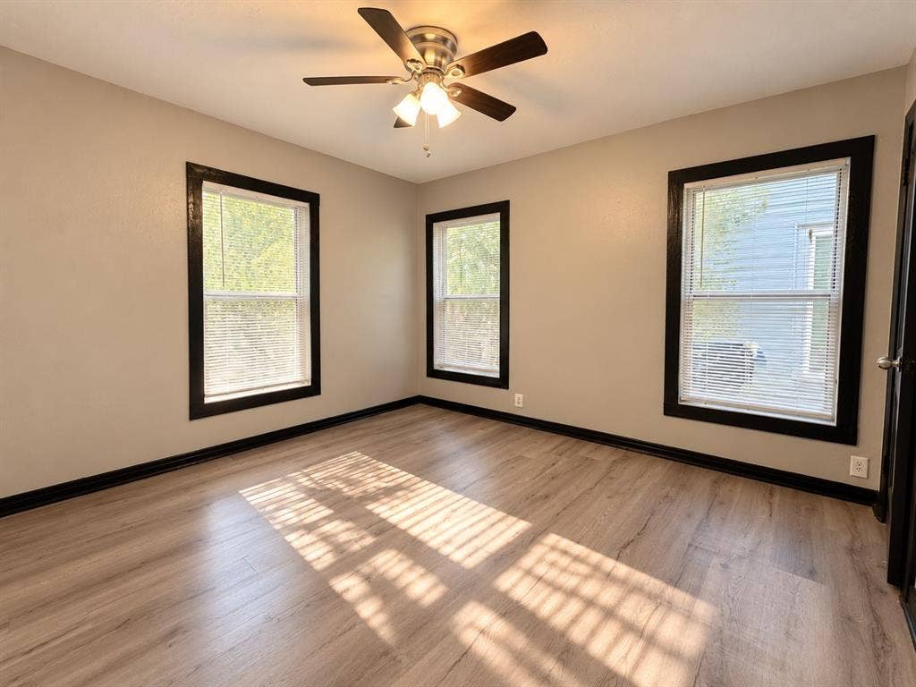 1817 N Alexander Street, Sherman, TX 75092 Versatile secondary bedroom with neutral tones and wood-look flooring.