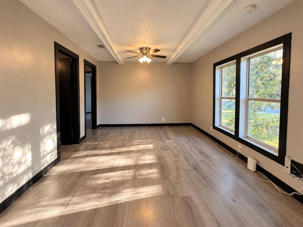 1817 N Alexander Street, Sherman, TX 75092 Comfortable living area with natural light and versatile furniture arrangement options.