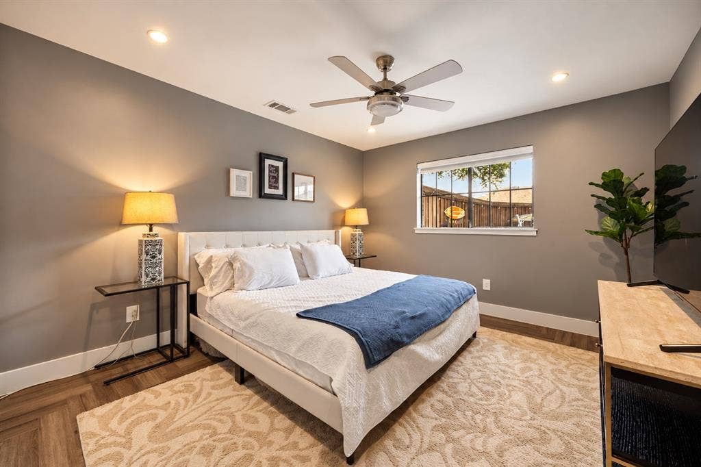5833 Gallant Fox Lane, Plano, TX 75093 Neutral-toned room featuring wood-finish flooring in a herringbone pattern, recessed lighting, and a multi-blade ceiling fan with integrated lighting