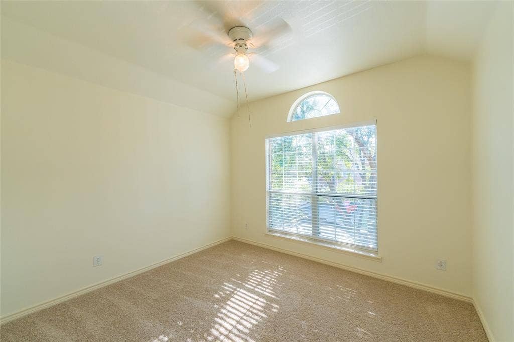 Vaulted ceiling, arched window, and overhead ceiling fan fixture