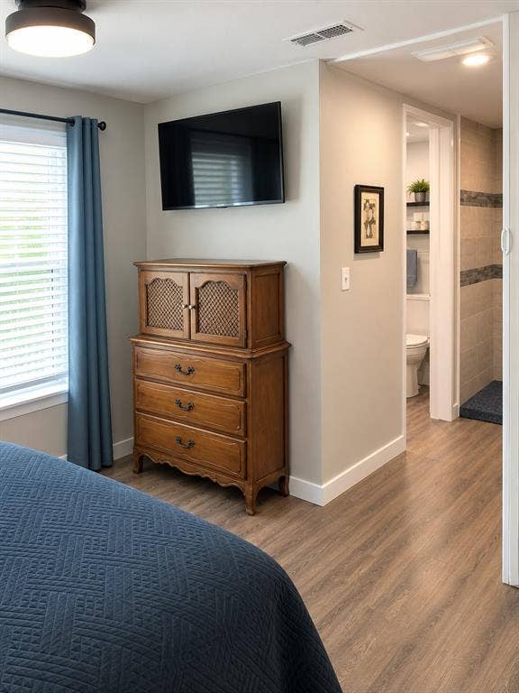 1579 Eastside Lake Road, Graham, TX 76450 Wood-finish vinyl flooring, neutral wall tones, recessed ceiling lighting, and a walk-through space featuring a tiled shower stall