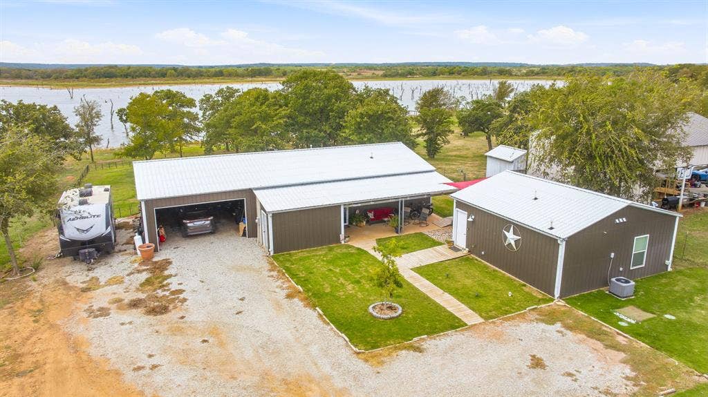 1579 Eastside Lake Road, Graham, TX 76450 Aerial View of improvements: The 1200 square foot main house with 600 square foot garage. The house with the Texas Star is a one bedroom handicap accessible efficiency apartment with kitchen, dining, bathroom, and laundry