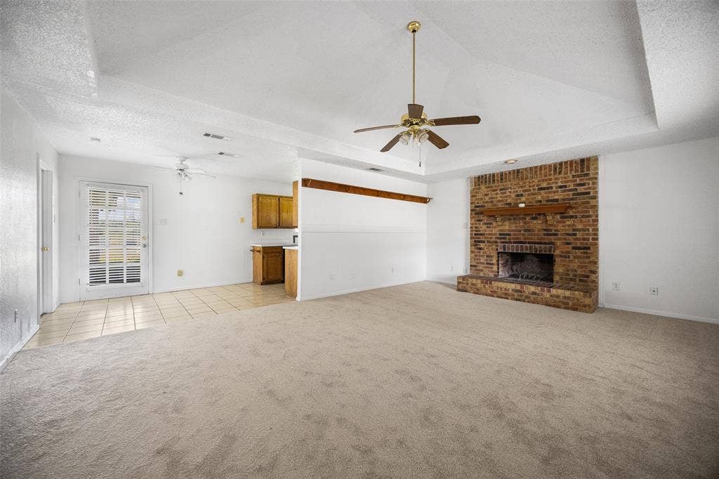 Brick fireplace and tray ceilings
