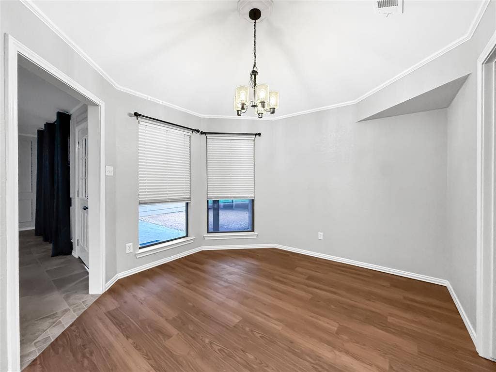 305 N Cottonbelt Avenue, Wylie, TX 75098 Bay window featuring dual vertical windows, wood-finish flooring, vaulted ceiling, and multi-light hanging chandelier