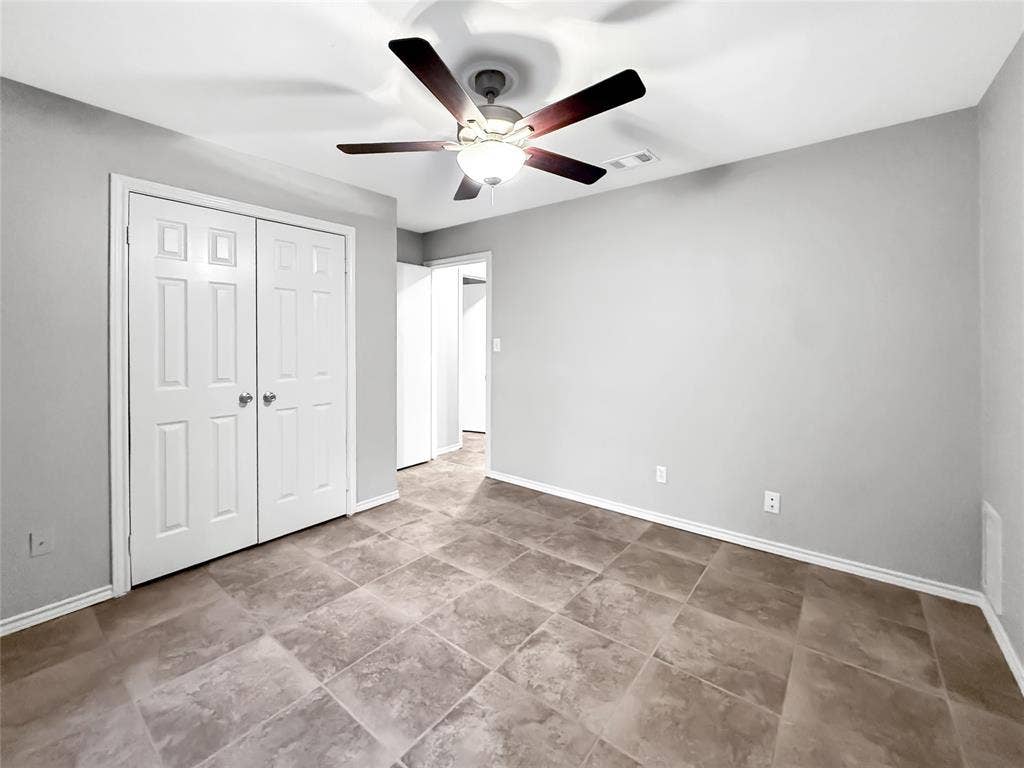305 N Cottonbelt Avenue, Wylie, TX 75098 Neutral-toned wall finish, large-format tile flooring, double-door closet, and integrated ceiling fan with light fixture