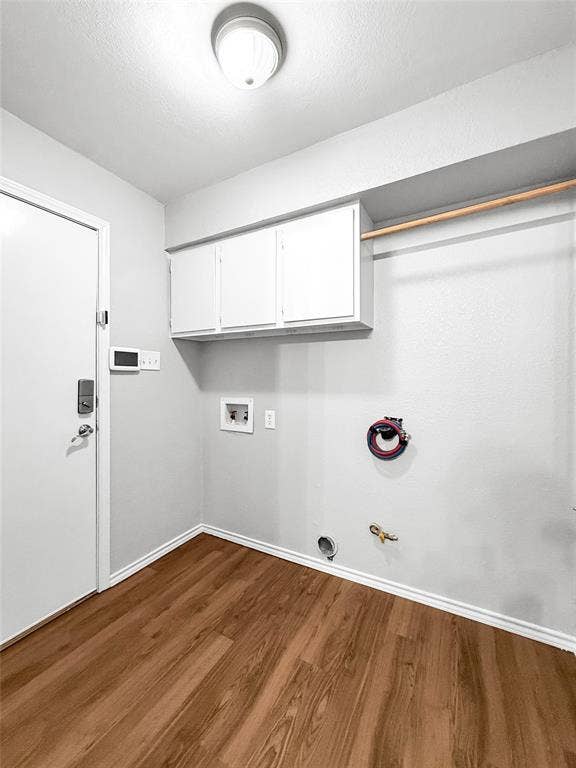 305 N Cottonbelt Avenue, Wylie, TX 75098 Utility space featuring wood-finish flooring, white wall-mounted cabinetry, a built-in hanging rod, dedicated water hookups, and a flush-mount ceiling light fixture