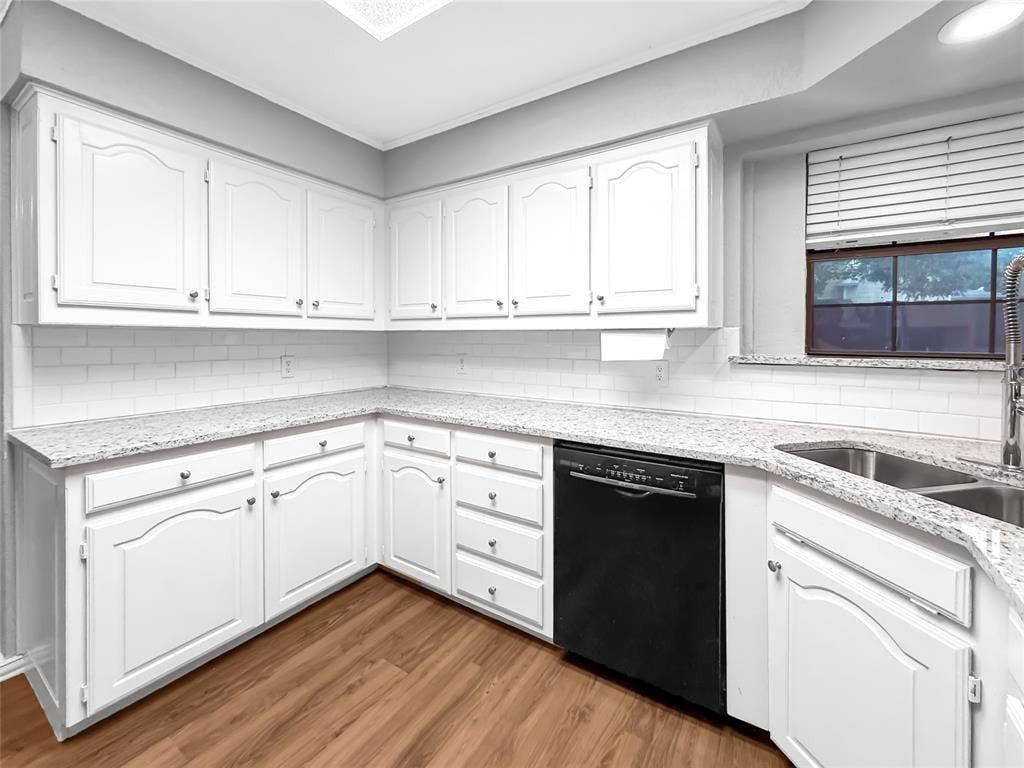 305 N Cottonbelt Avenue, Wylie, TX 75098 Kitchen featuring white cabinetry, stone-finish countertops, subway tile backsplash, wood-finish flooring, and a stainless steel kitchen faucet