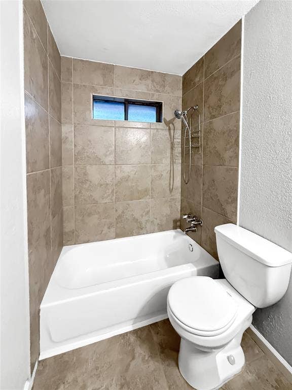 305 N Cottonbelt Avenue, Wylie, TX 75098 Full-size bathtub with surrounding large-format neutral-tone tile, handheld showerhead, and a horizontal privacy window