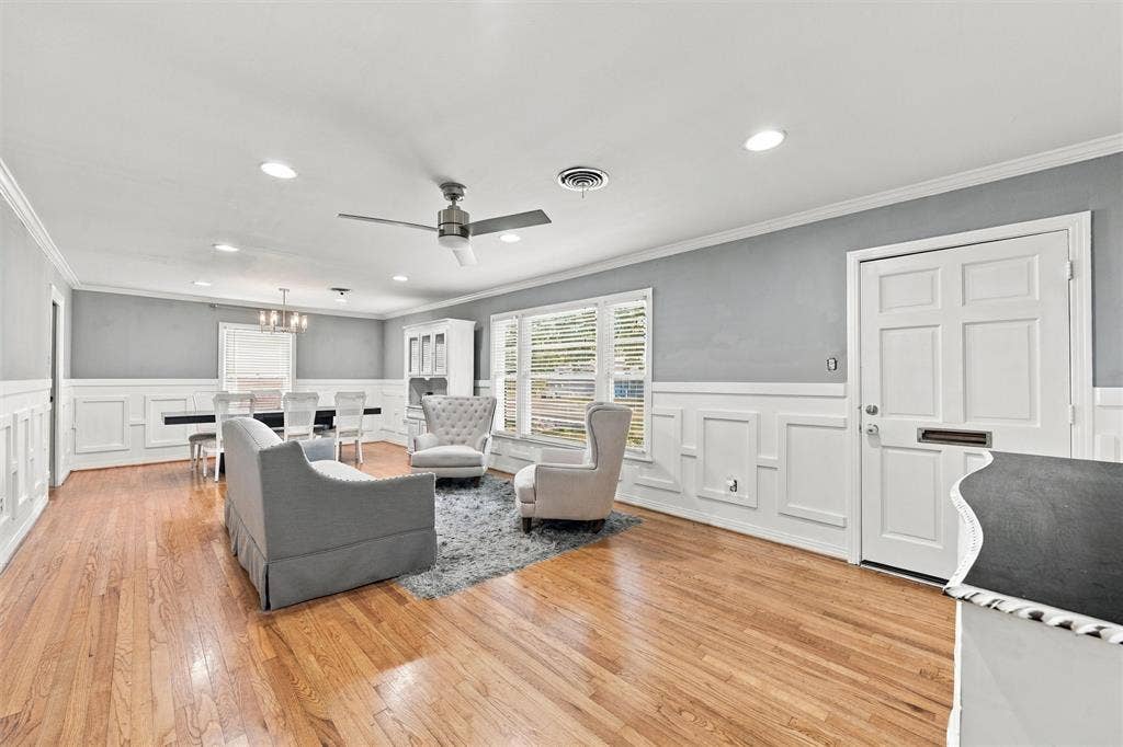 Interior space featuring wood-finish flooring, decorative wall wainscoting, recessed lighting, and a ceiling fan