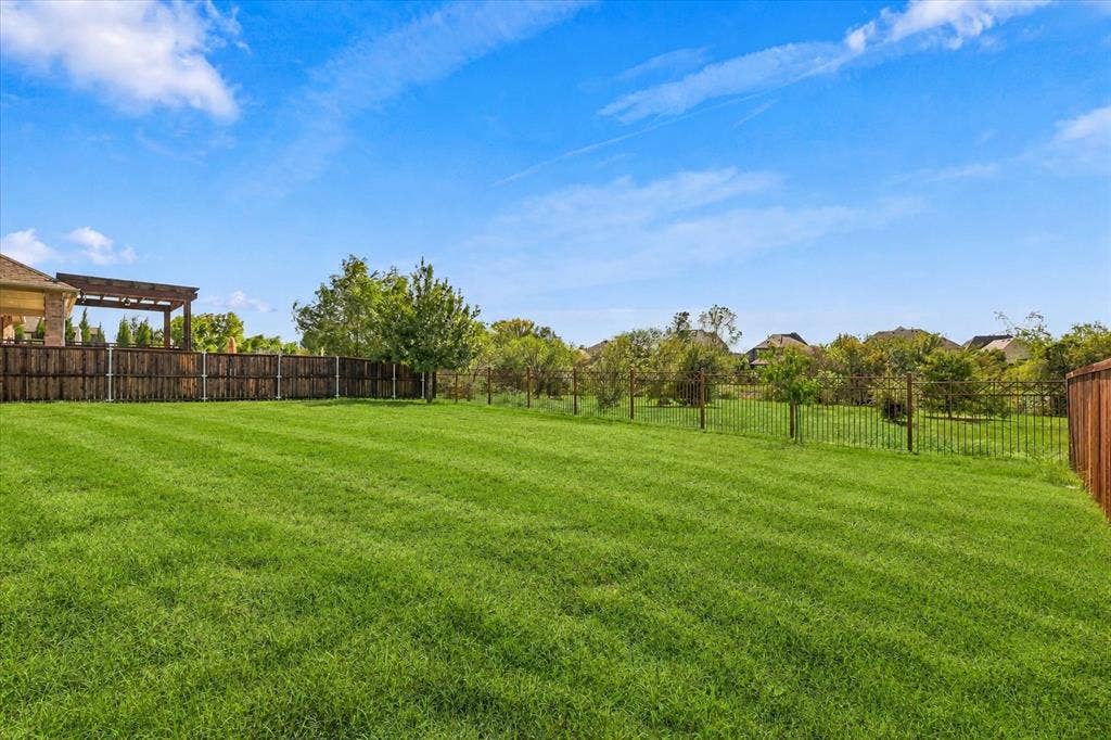 6417 Dolan Falls Drive, Northlake, TX 76226 Large backyard that backs to greenspace offers extraoridinary privacy behind. This includes views of a community pond.