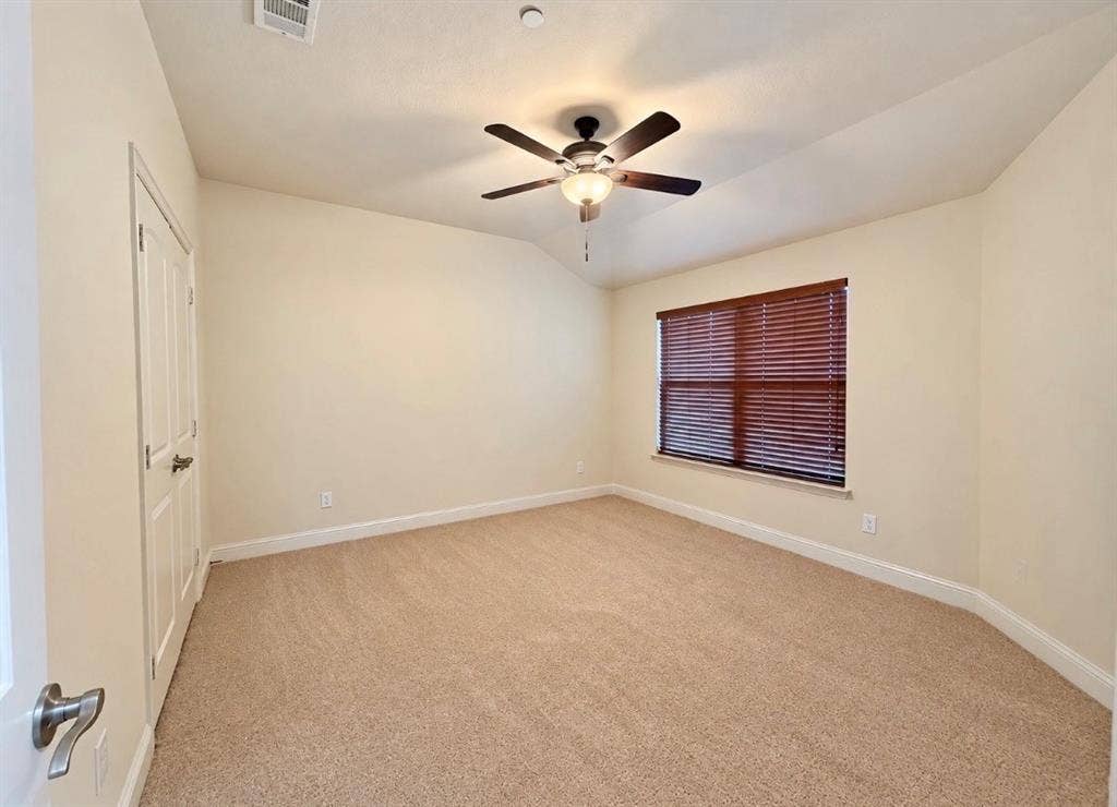 8616 Naomi Street, Plano, TX 75024 Room featuring vaulted ceilings, neutral wall tones, wall-to-wall carpeting, a ceiling fan with integrated light fixture, and window blinds