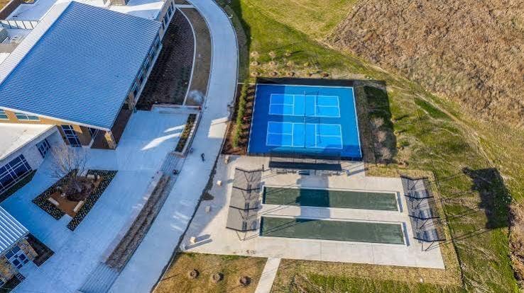 9096 Phoebe Road, Frisco, TX 75035 Recreational area featuring a dual pickleball court, two bocce ball courts, concrete hardscaping, and landscaped garden beds