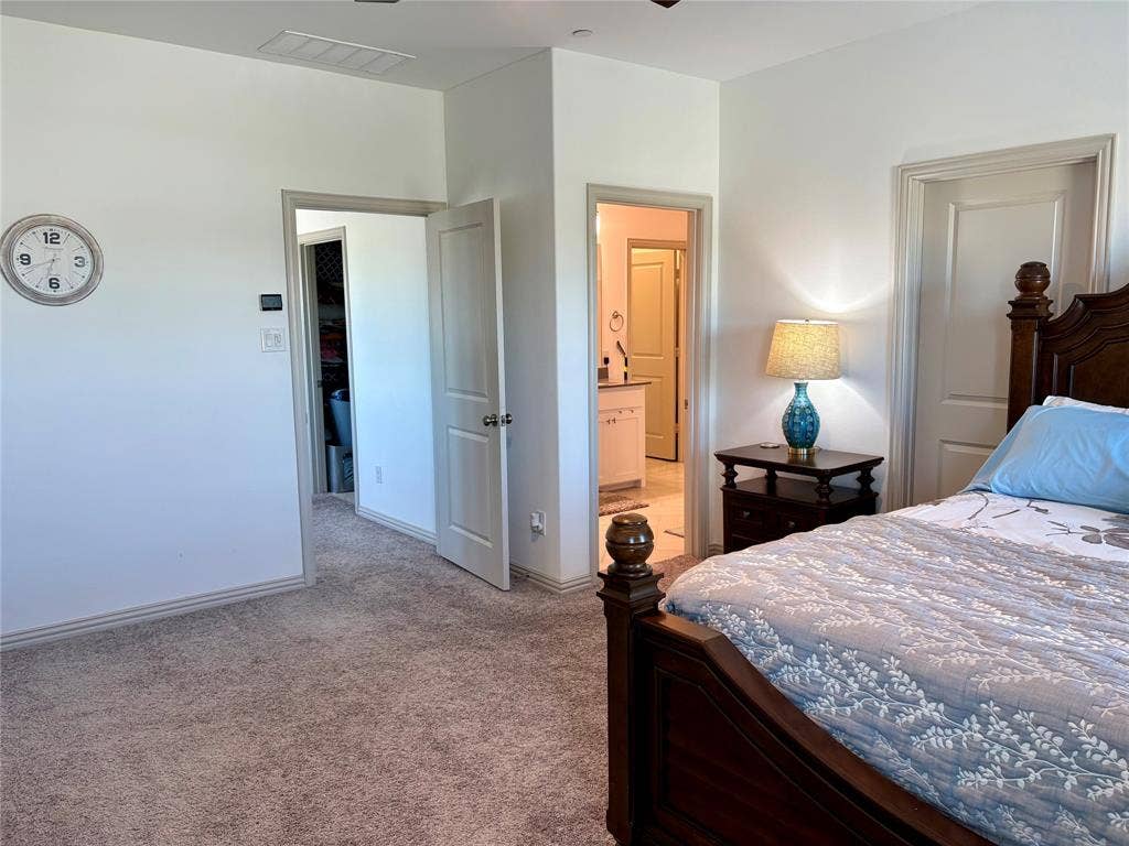 9096 Phoebe Road, Frisco, TX 75035 Neutral-toned wall-to-wall carpeting, multiple interior doors with polished hardware, and built-in entryways