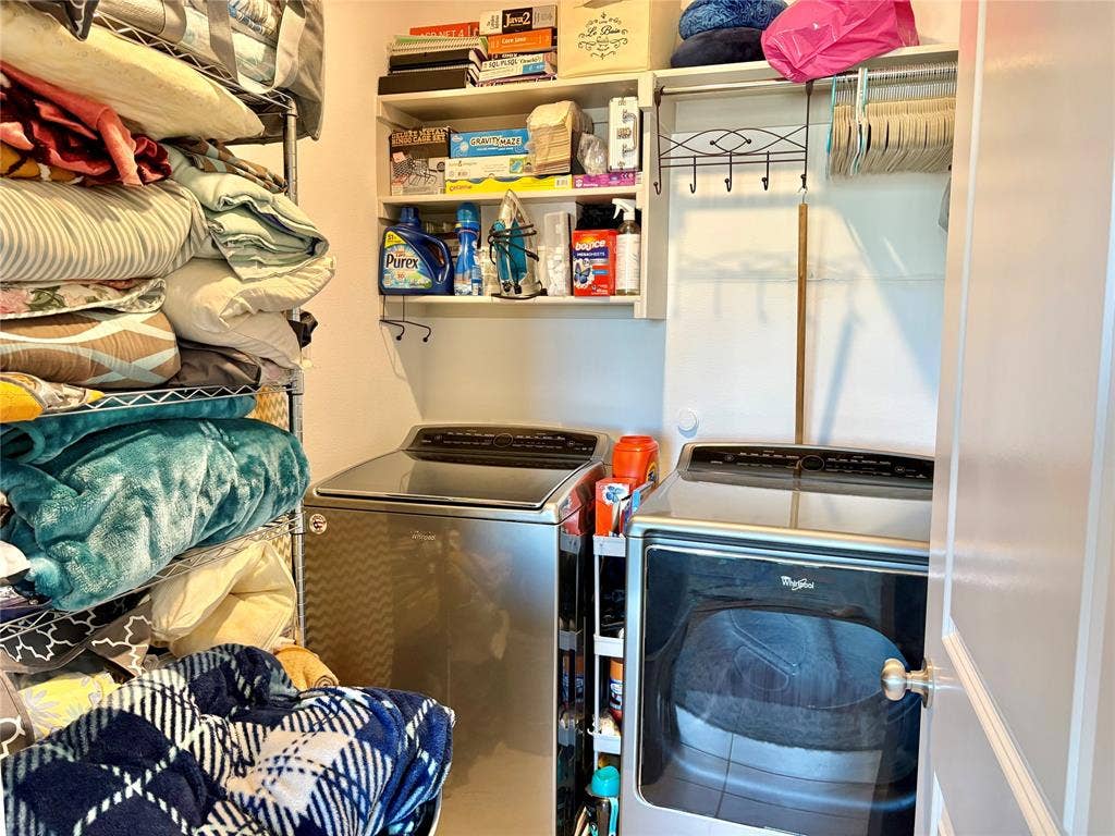 9096 Phoebe Road, Frisco, TX 75035 Laundry space featuring built-in white shelving, an integrated clothing rod with decorative hardware, and metallic finish appliance hookups