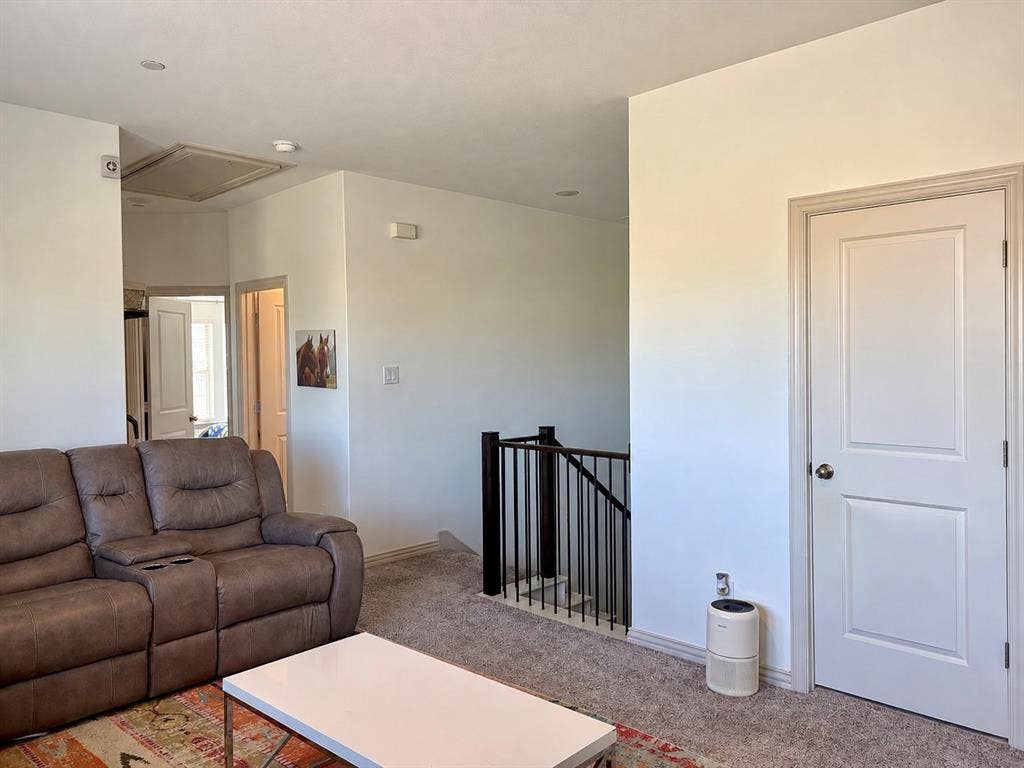 9096 Phoebe Road, Frisco, TX 75035 Neutral-toned carpeting, recessed ceiling lighting, and a staircase featuring a metal balustrade