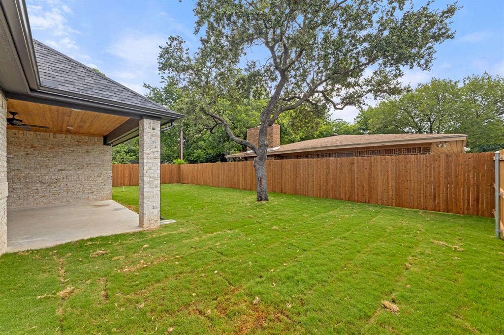 View of yard with a fenced backyard and a patio area