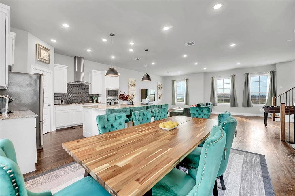 Dining area featuring dark wood-style flooring and recessed lighting