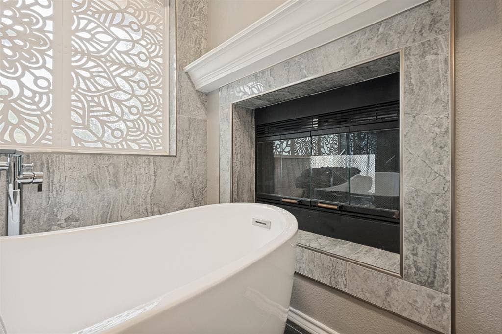 Enjoy relaxing in a hot tub near the fireplace after a long day.